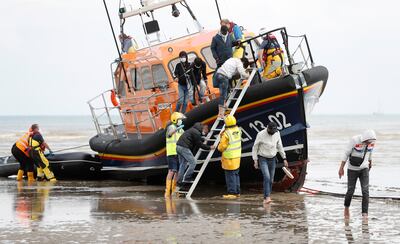 Migrants from nations including Vietnam, Iran and Eritrea disembark a RNLI vessel in Dungeness after being rescued in the English Channel, having departed from northern France to seek asylum in the UK. Reuters
