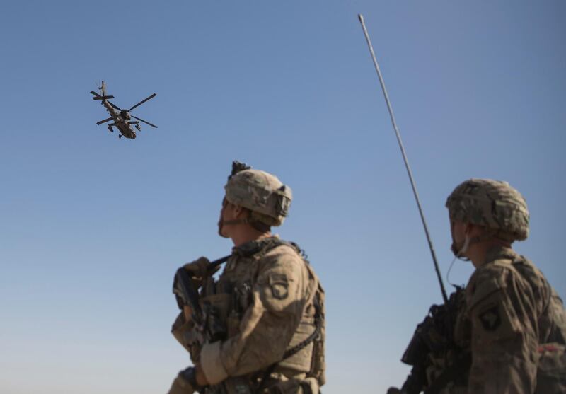 FILE - This June 10, 2017 file photo released by the U.S. Marine Corpsshows an AH-64 Apache attack helicopter provides security from above while CH-47 Chinooks drop off supplies to U.S. Soldiers with Task Force Iron at Bost Airfield, Afghanistan. When he pulled the plug on the American war in Afghanistan, President Joe Biden said the reasons for staying, 10 years after the death of al-Qaida leader Osama bin Laden, had become "increasingly unclear.â€ Now that the final withdrawal is under way, questions about clarity have shifted to Biden's post-withdrawal plan. (U.S. Marine Corps photo by Sgt. Justin T. Updegraff, Operation Resolute Support via AP)