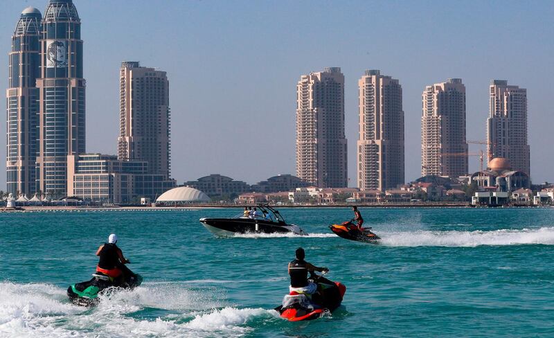 Youth ride jet-skis at Katara beach in the Qatari capital Doha on July 1, 2020 as the country moves into the second phase of its four-step plan to lift COVID-19 lockdown. / AFP / KARIM JAAFAR
