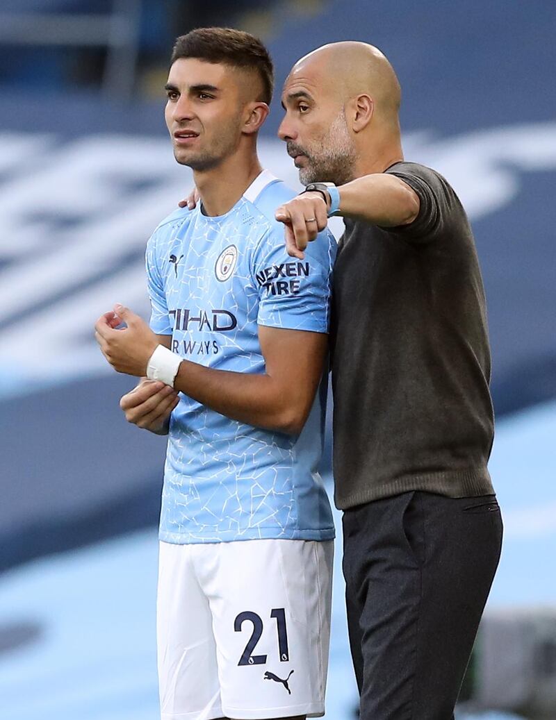Manchester City's Spanish midfielder Ferran Torres receives instructions from manager Pep Guardiola. AFP
