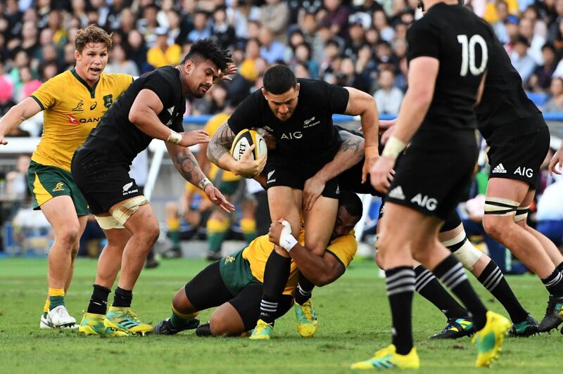 New Zealand's centre Sonny Bill Williams (C) is tackled during the Bledisloe Cup rugby union Test match between the New Zealand All Blacks and Australia at Yokohama International Stadium in Yokohama on October 27, 2018. / AFP / Toshifumi KITAMURA
