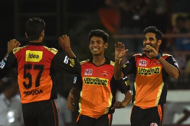 Sunrisers Hyderabad’s Deepak Hooda, Mustafizur Rahman, centre, and Bhuvneshwar Kumar celebrate after the wicket of Gujarat Lions’ Dinesh Karthik during the 2016 Indian Premier League (IPL) Twenty20 cricket match between Gujarat Lions and Sunrisers Hyderabad at the Saurashtra Cricket Association Stadium in Rajkot on April 21, 2016. Indranil Mukherjee / AFP