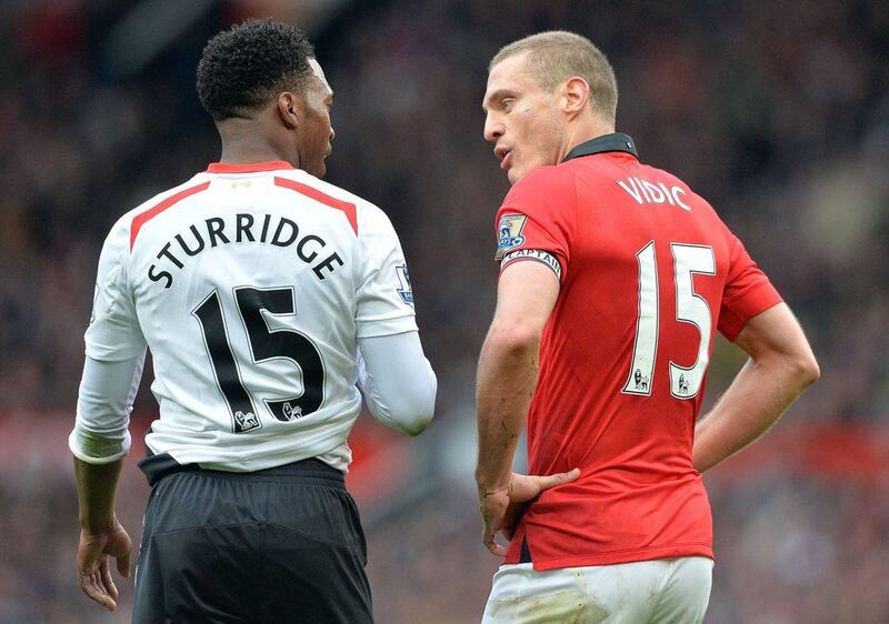 Liverpool forward Daniel Sturridge, left, exchanges words with Manchester United defender Nemanja Vidic on Sunday. Paul Ellis / AFP / March 16, 2014 