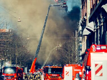 Firefighters tackle a fire at Borsen, Denmark’s old stock exchange building, in Copenhagen, Denmark, on Tuesday, April 16, 2024.  The fire has torn down the structure’s dragon-tail spire, a Copenhagen landmark. Photographer: Jeppe Boje Nielsen / Bloomberg