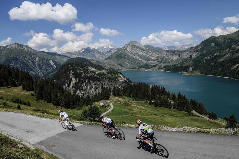 France's Elie Gesbert, Colombia's Darwin Atapuma and Belgium's Serge Pauwels ride down past the Roselend Lake during their breakaway in the eleventh stage of the Tour de France. Philippe Lopez / AFP