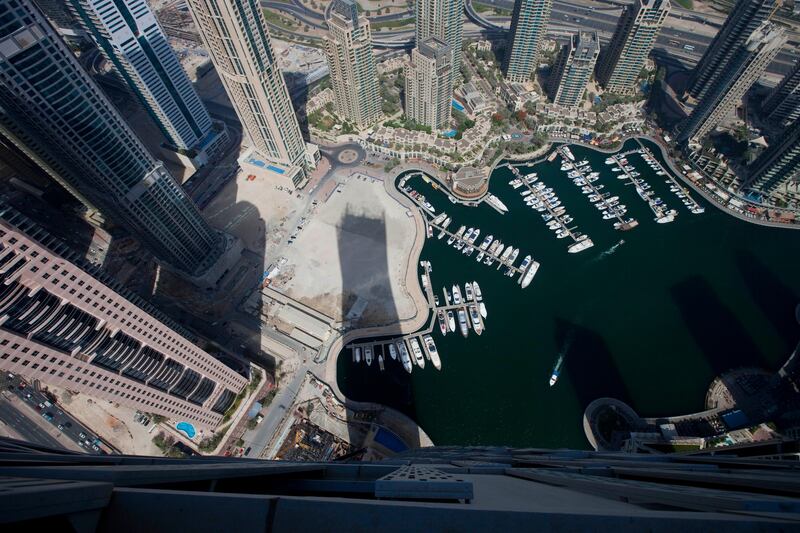 Dubai, United Arab Emirates - June 11 2013 - The shadow of the Cayan Tower is seen along the Dubai Marina view from the 72nd floor penthouse apartment at the Cayan Tower in the Dubai Marina.  (Razan Alzayani / The National)