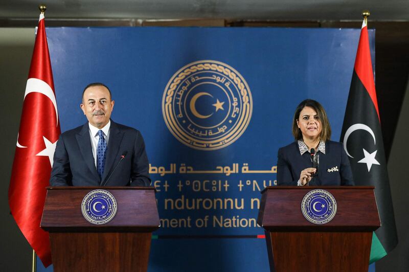 (R to L) Libya's Foreign Minister Najla al-Mangoush and Turkish counterpart Mevlut Cavusoglu give a joint press conference in the capital Tripoli on May 3, 2021.  / AFP / Mahmud Turkia
