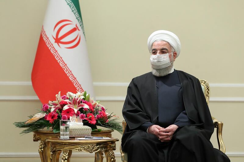 In this photo released by the official website of the office of the Iranian Presidency, President Hassan Rouhani meets with Irish Foreign Minister Simon Coveney, in Tehran, Iran, Sunday, March 7, 2021. Rouhani said Sunday his country is prepared to take steps to live up to measures in the 2015 nuclear deal with world powers as soon as the United States lifts economic sanctions on Iran (Iranian Presidency Office via AP)