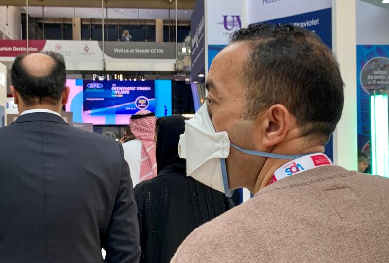A visitor wearing a protective face mask at the Arab Health conference held at Dubai World Trade Centre in Dubai on January 29, 2020. Pawan  Singh / The National
