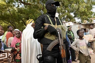 A police officer stands guard at a market near Diffa airport in south-eastern Niger, near the border with Nigeria, on December 23. AFP 