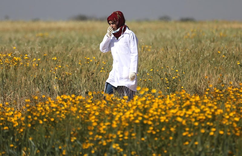 Female Palestinian medic Razan Al-Najar works at the scene of clashes at Israel-Gaza border, in the southern Gaza Strip April 1, 2018. Picture taken April1, 2018. REUTERS/Ibraheem Abu Mustafa - RC1687202A00