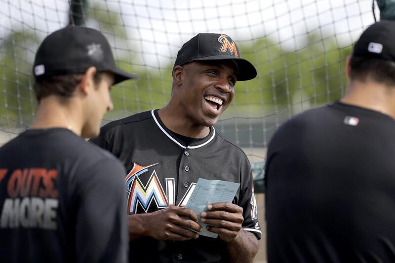 Miami Marlins hitting coach Barry Bonds laughs as he chats with players during spring training baseball practice Monday, Feb. 22, 2016, in Jupiter, Fla. (AP Photo/Jeff Roberson) 