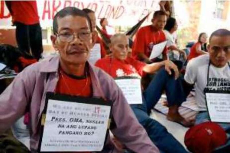 Jose Angeles sits outside the Philippines House of Representatives on Wednesday. He and other landless farmers went on a hunger strike to convince the government to extend a land redistribution program past its Dec 31 expiration date.

Credit: Jared Ferrie/The National *** Local Caption ***  Ferrie-Farmers1.JPG