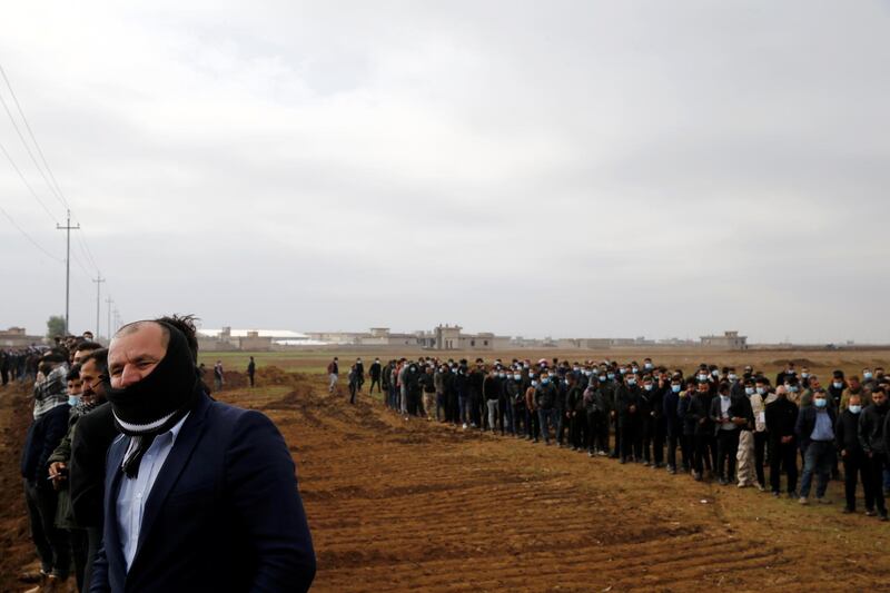 Mourners attend the funeral of 104 Yazidis from the village of Kocho who were killed by ISIS and buried in mass graves before their remains were exhumed and identified. Reuters