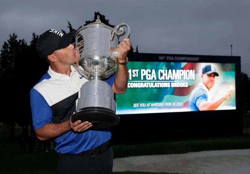 Brooks Koepka kisses the Wanamaker Trophy. AP Photo