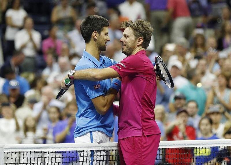Stan Wawrinka, right, and Novak Djokovic embrace at the net after Wawrinka beat the Serb 6-7, 6-4, 7-5, 6-3 to win the men’s US Open final. John Mabanglo / EPA