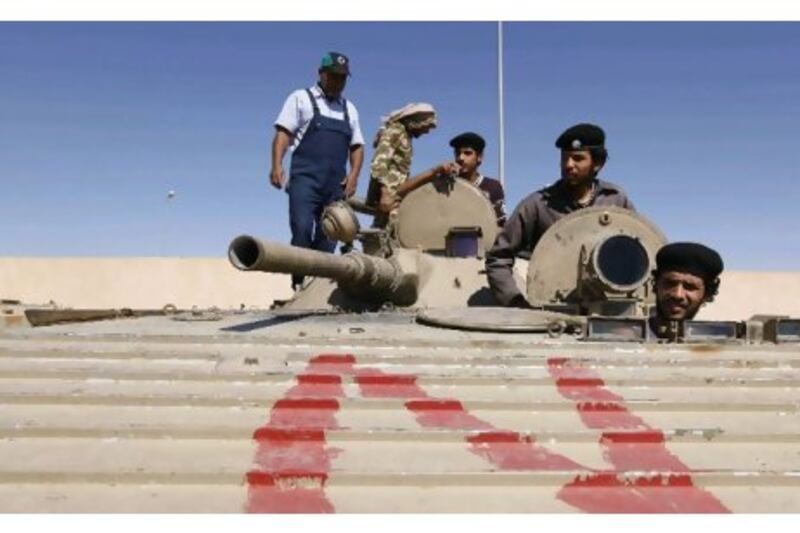 Rebels carry out training with a captured Qaddafi armoured vehicle in the city of Zinta. Anis Mili / Reuters