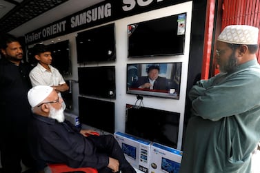 Men in Karachi watch a televised speech by Prime Minister Imran Khan after Pakistan shot down two Indian military aircraft. Reuters/Akhtar Soomro