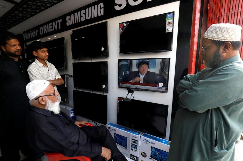 Shopkeepers watch the speech of Pakistani Prime Minister Imran Khan, after Pakistan shot down two Indian military aircrafts, at a shop selling television screens in Karachi, Pakistan February 27, 2019. REUTERS/Akhtar Soomro