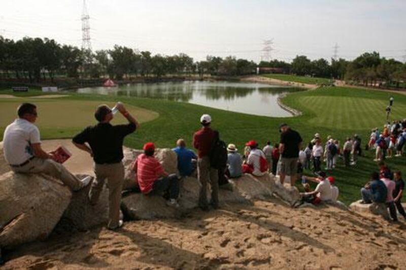 Fans line the 12th green to watch Rory Mcilroy, Paul Casey and Miguel Angel Jimenez at the Abu Dhabi HSBC Golf Championship.