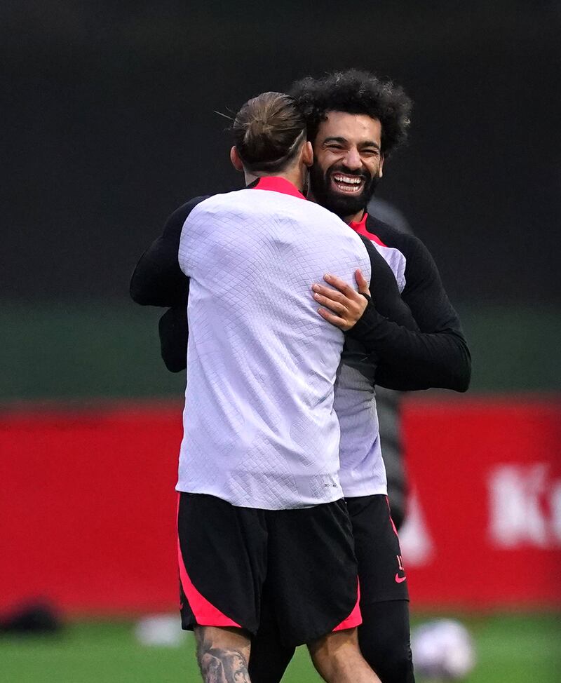 Liverpool's Kostas Tsimikas and Mohamed Salah during training. PA