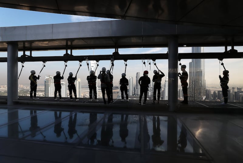 Jamie Goodwin, second from right, during the Sky Edge Walk. Pawan Singh / The National