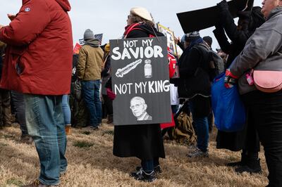 A demonstrator holds a sign during an anti-vaccine mandate rally at the Lincoln Memorial on the National Mall in Washington, US, on January 23. Bloomberg 