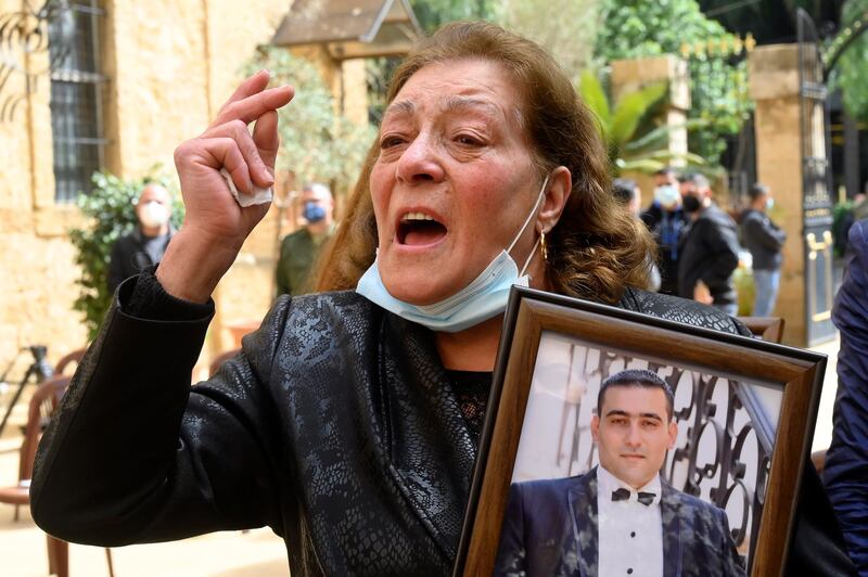 A woman shouts slogans as she carries a picture of her son one of the victims of Beirut port explosion during the ceremony on the occasion of Mother's Day in Beirut, Lebanon. EPA