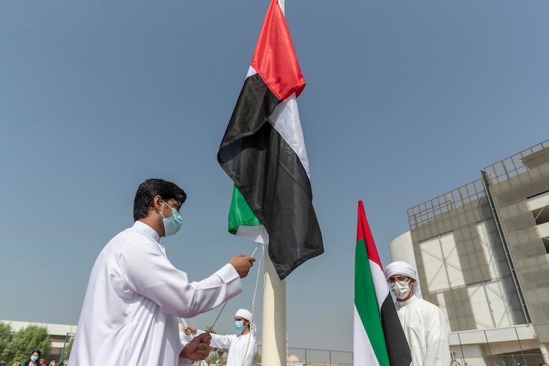 Pupils also raised UAE flags. Antonie Robertson / The National