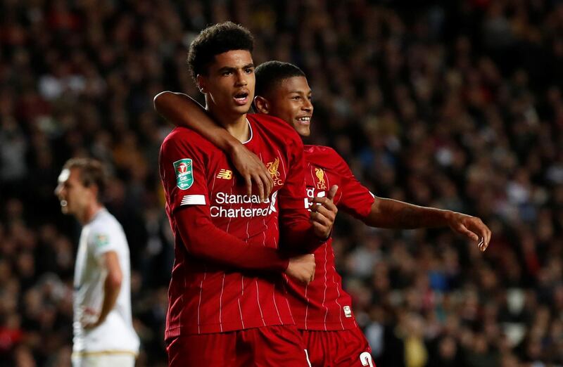 Ki-Jana Hoever, 17, celebrates Liverpool's second goal with another teenager, 19-year-old Rhian Brewster. Reuters