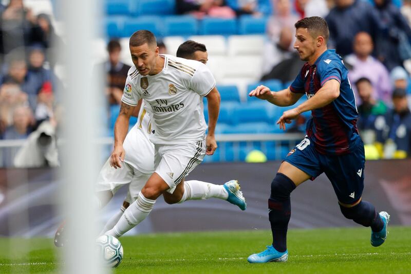 Real Madrid's Eden Hazard, left, vies for the ball with Levante's Enis Bardhi. AP Photo