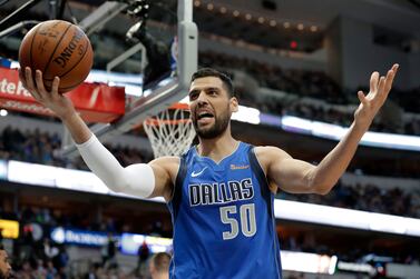 FILE - In this Friday, Feb.  22, 2019 file photo, Dallas Mavericks center Salah Mejri in action during the team's NBA basketball game against the Denver Nuggets in Dallas.  While the AfroBasket tournament doesn’t boast the star power of an Olympics, it does showcase ever-competitive and improving quality of basketball on the continent.  Mejri, a more slender 7-foot-2 center who played for the Dallas Mavericks from 2015-19, hopes to use his 3-point shooting to draw former NBA draft pick Walter “Edy” Tavares away from the basket.  Ugandan players struggled in the paint, knowing Tavares was looming to swat away shots.  (AP Photo / Tony Gutierrez, file)