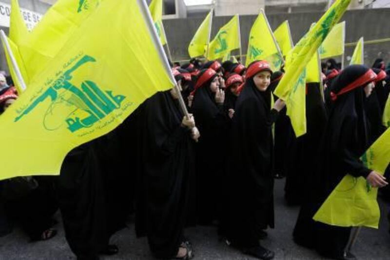 Young veiled Hezbollah supporters carry their flag during a rally denouncing an anti-Islam film that has provoked a week of unrest in Muslim countries worldwide, in the southern suburb of Beirut, Lebanon, Monday Sept. 17, 2012. Hezbollah's leader Hassan Nasrallah, not shown, who does not usually appear in public for fear of assassination, called for Monday's protests in Beirut, saying the U.S. must be held accountable for the film because it was produced in America. (AP Photo/Hussein Malla)