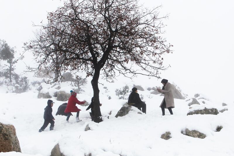 Children play with snow as a woman takes a picture with her mobile phone, in the town of Jezzine, southern Lebanon. Reuters