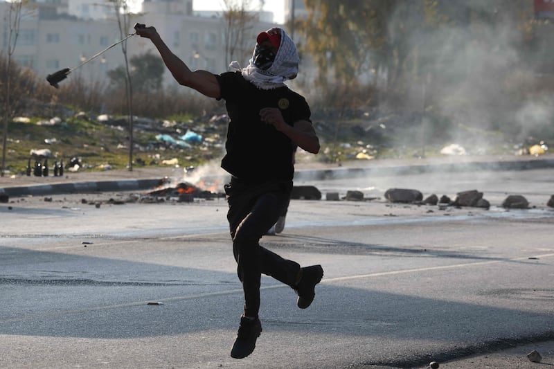 A protester throws a stone at Israeli forces during the demonstration. AFP