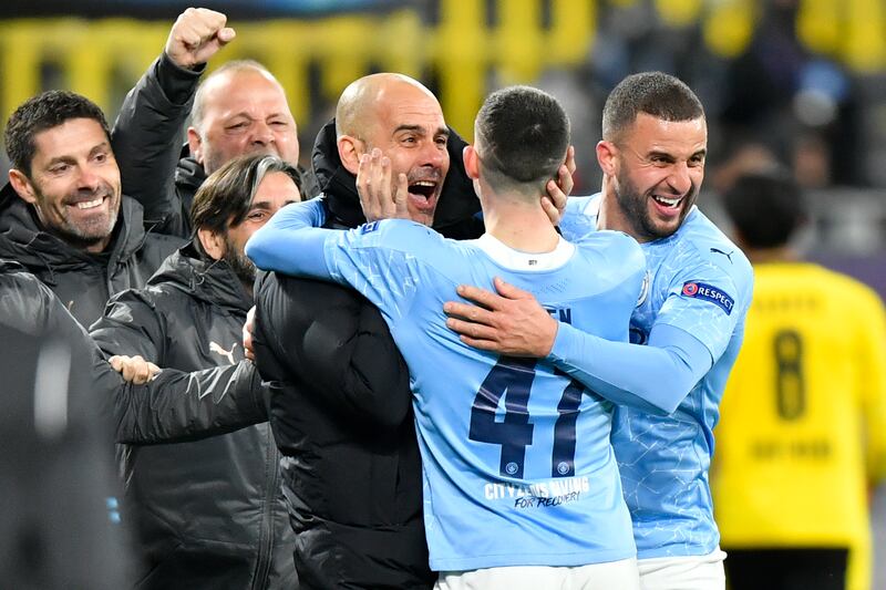 Manchester City manager Pep Guardiola celebrates with goalscorer Phil Foden and Kyle Walker. PA