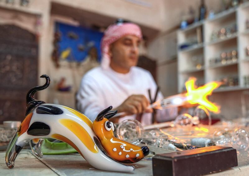 Abu Dhabi, United Arab Emirates, July 23, 2019.  VB:  Photo project at the Heritage Village, Corniche.  Local craftsworkers conduct workshops in traditional metalwork, pottery, glass blowing and Arabic cloak making. --  Noor Ahmad-47, Arabic glass blowing artist busy in his workshop at Heritage Villlage.
Victor Besa/The National
Section:  NA
Reporter: