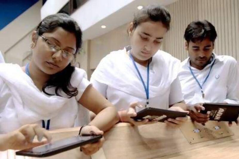 A group of students tries the Aakash low-cost tablet after its launch in October 2011. Pankaj Nangia / Bloomberg