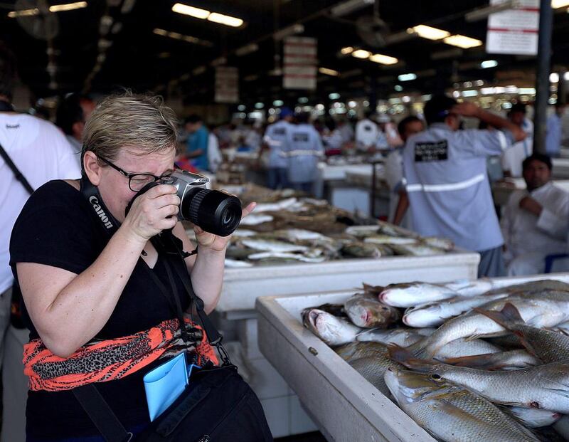 Mari Williams zooms in at the fish market. Satish Kumar / The National 