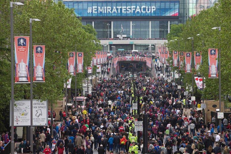 Football fans arrive at Wembley Stadium in north London on May 21, 2016, ahead of the English FA Cup final football match between Crystal Palace and Manchester United at Wembley Stadium in London. Justin Tallis / AFP