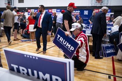 Volunteers build campaign yard signs before a visit by former US President Donald Trump in Grimes, Iowa, on June 1. Bloomberg 