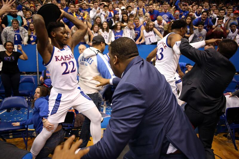 Silvio De Sousa of the Kansas Jayhawks picks up a chair during a brawl as the US college basketball game against the Kansas State Wildcats ends in chaos at Allen Fieldhouse on Tuesday, January 21. AFP