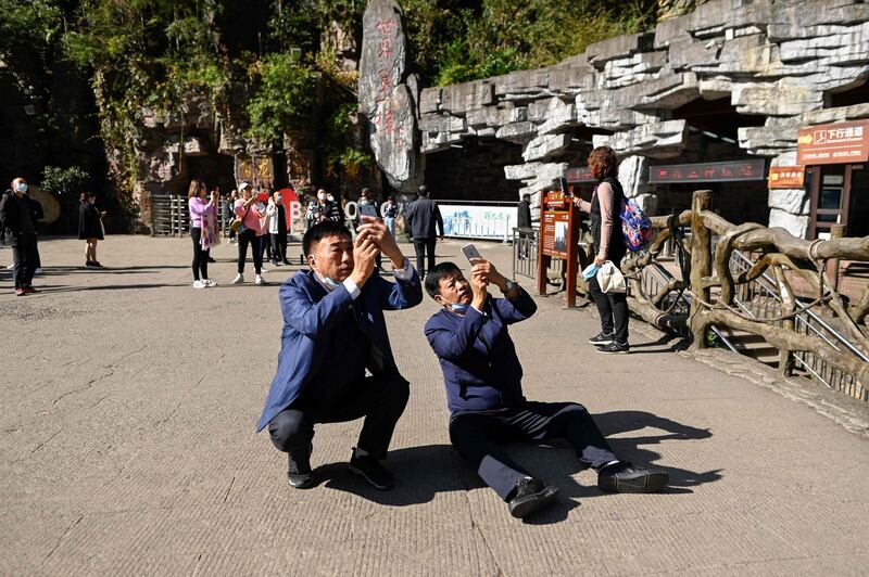 Tourists take pictures of the elevators. AFP