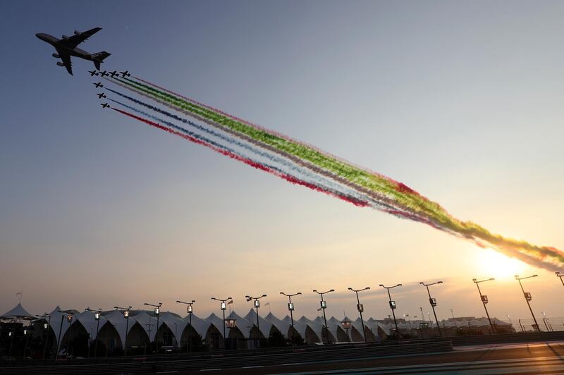 Planes spray the UAE flag colours over the track ahead of the Grand Prix at the Yas Marina racetrack. AP Photo