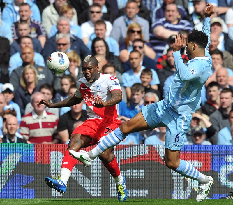 Manchester City's defender Joleon Lescott  vies with Queens Park Rangers' striker Djibril Cisse. AFP