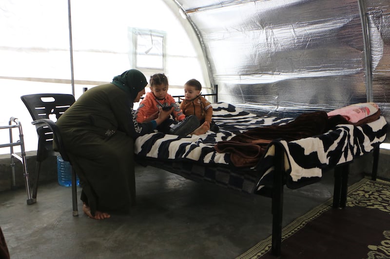 They now live with their grandmother Soa'ad Al Ahmed in a temporary tent shelter. Abd Almajed Alkarh for The National