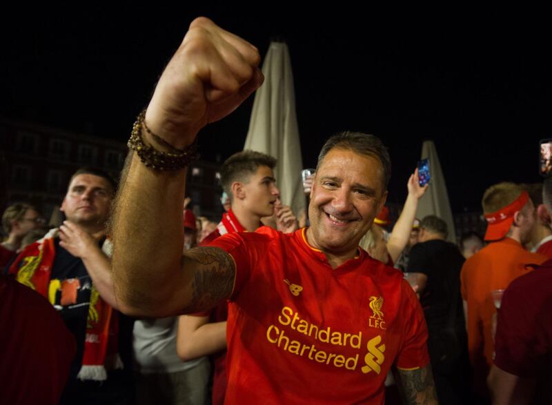 A Liverpool fan punches the air in delight. AFP