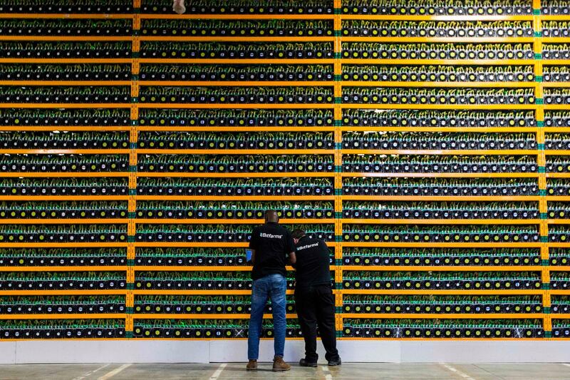 (FILES) In this file photo taken on March 19, 2018 Two technicians inspect bitcon mining at Bitfarms in Saint Hyacinthe, Quebec. Investors in a cryptocurrency exchange who lost access to tens of millions of dollars when the website's Canadian founder died abruptly, are demanding his body be exhumed to rule out any chance that he faked his own death. The case focuses on the sudden death of QuadrigaCX founder Gerald Cotten, who passed away aged 30 from Crohn's disease, an inflammatory bowel condition, in December 2018 while traveling in India, taking all the passwords to the site's funds with him to the grave.
 - 
 / AFP / Lars Hagberg
