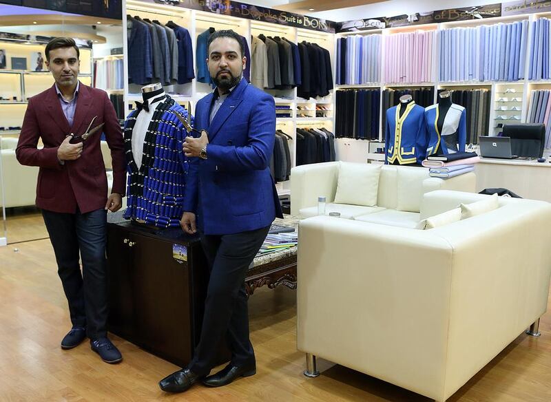 Knights & Lords owners Pawan Ishwar, left, Ashish Ishwar get about three to four new commissions in a day, resulting in around 45 new suits being made a month. Satish Kumar / The National