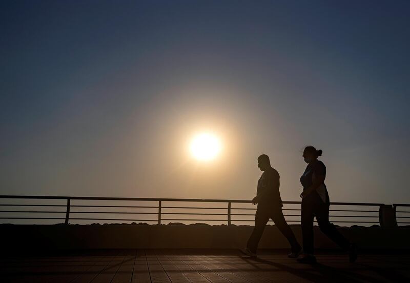 Dubai, United Arab Emirates - Reporter: N/A. News. Weather. A couple walk on the boardwalk in the summer heat. Wednesday, July 8th, 2020. The Palm, Dubai. Chris Whiteoak / The National